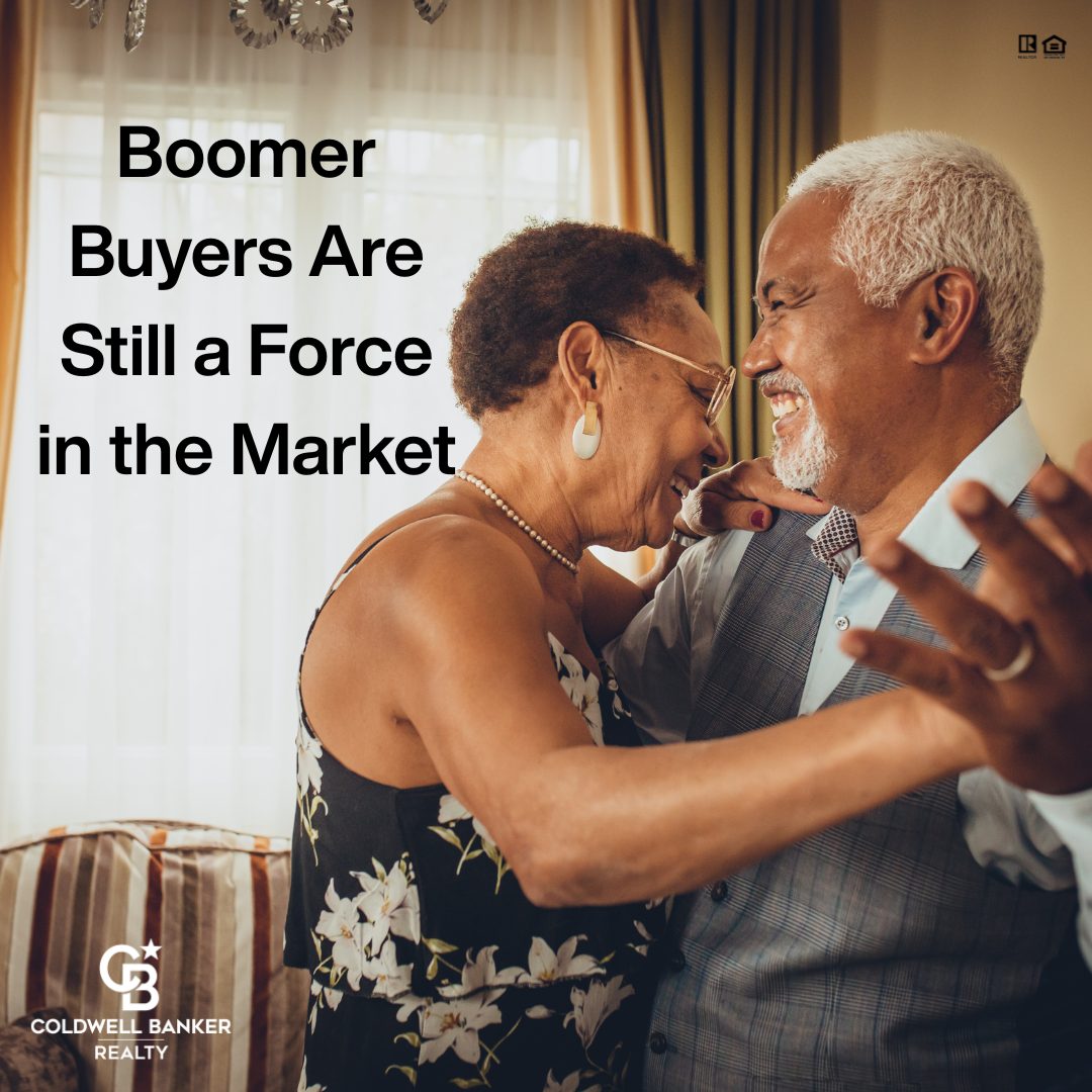 Smiling older couple embracing in a cozy living room, symbolizing confident Baby Boomer homebuyers.