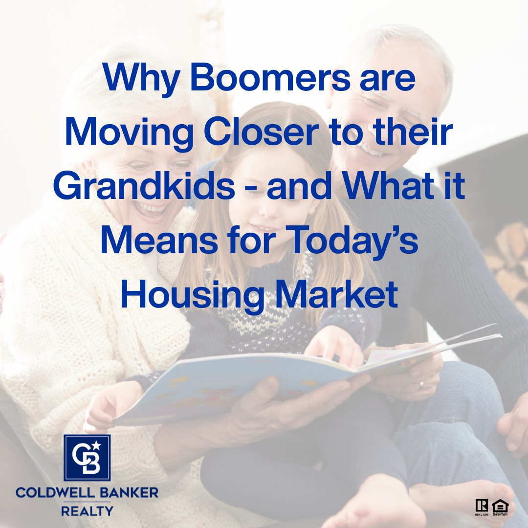Smiling grandparents sitting with a young grandchild on their lap while reading a picture book together in a cozy living room, representing family connection and real estate decisions focused on moving closer to grandchildren. Coldwell Banker Realty branding visible.