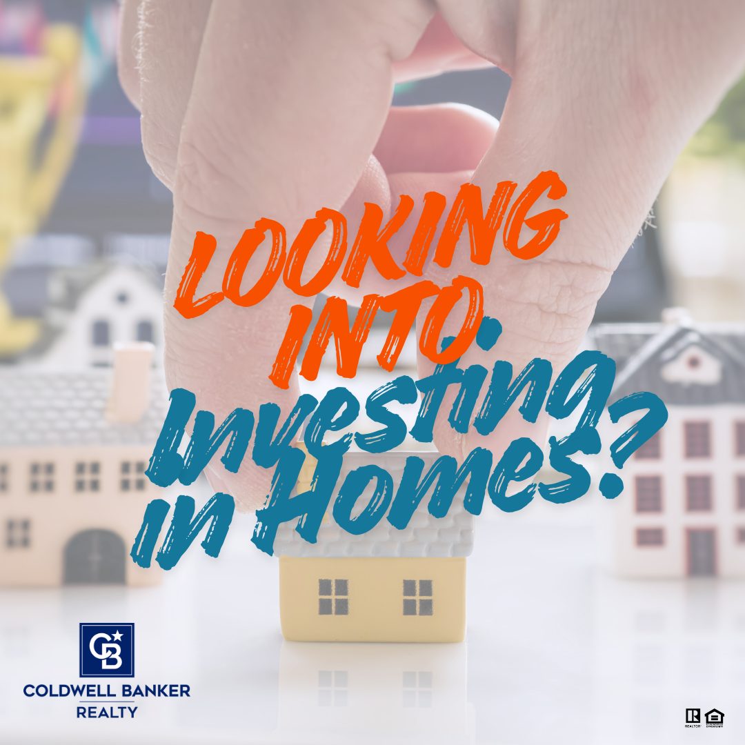 A close-up of a hand holding a small model house with bold text reading “Looking Into Investing in Homes?” over miniature homes in the background, along with the Coldwell Banker Realty logo.
